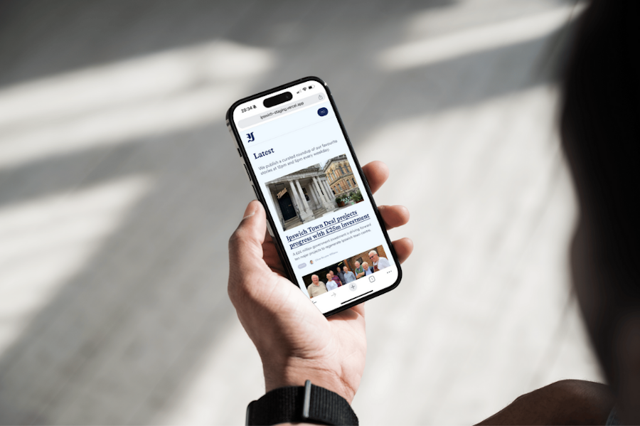Photo of a person browsing the Ipswich.co.uk website on their iPhone